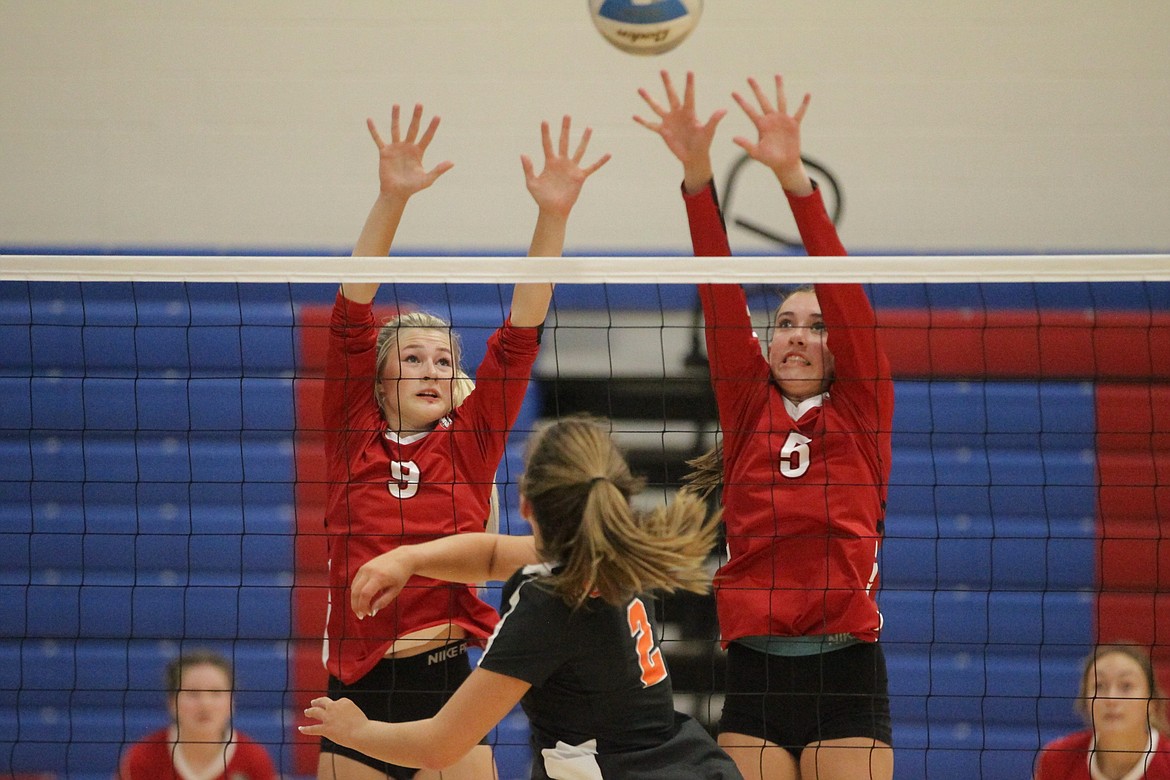 Kenzie Eden (9) and Aubree Lane (5) of Sandpoint go up for the block against the hitting attempt of Vanessa Kison (2) of Post Falls on Tuesday at a high school volleyball jamboree at Coeur d'Alene High. The seven-team jamboree also included Lake City, Lakeland, Coeur d'Alene, St. Maries and Moscow.