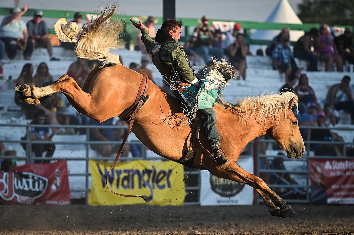 Bubba Holcomb, from New Harmony, Utah, rides Vitalix Wrecking Ball during bareback riding at the Northwest Montana Fair & Rodeo on Thursday, Aug. 18. (Casey Kreider/Daily Inter Lake)