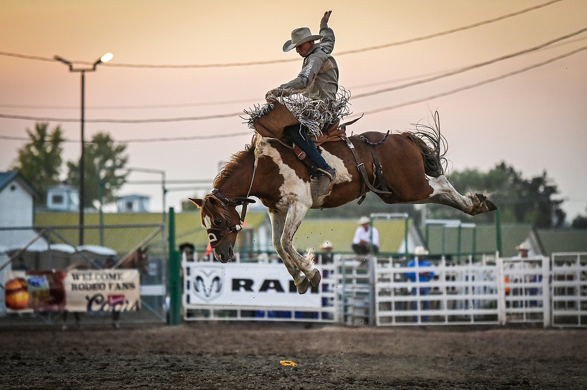 Josh Davison, from Miles City, competes in saddle bronc riding at the Northwest Montana Fair & Rodeo on Thursday, Aug. 18. (Casey Kreider/Daily Inter Lake)