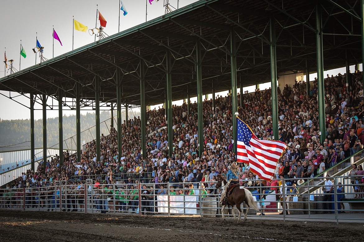 The crowd stands for the national anthem before the start of the  Northwest Montana Fair & Rodeo on Thursday, Aug. 18. (Casey Kreider/Daily Inter Lake)
