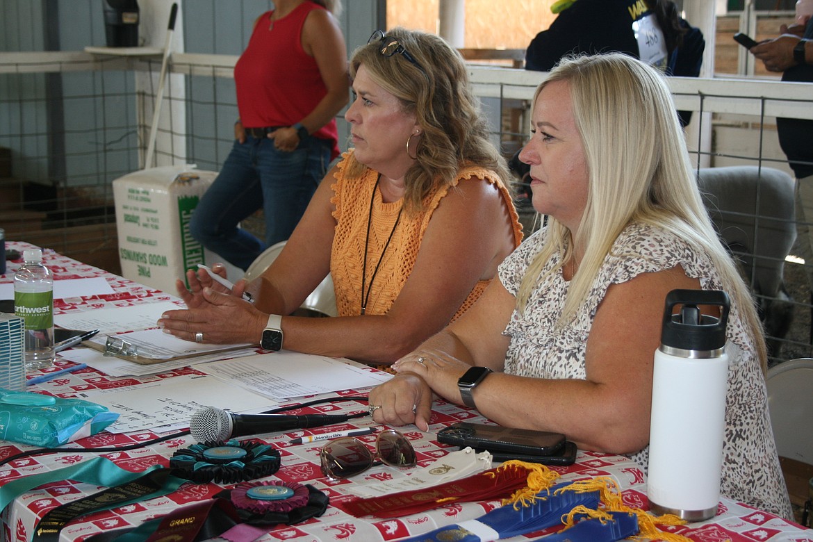 Volunteers Tawna Sandman, left, and Jana Raymond, right, oversee the lamb fitting and showing competition at the Grant County Fair Thursday. Hundreds of volunteers make the fair possible, organizers said.