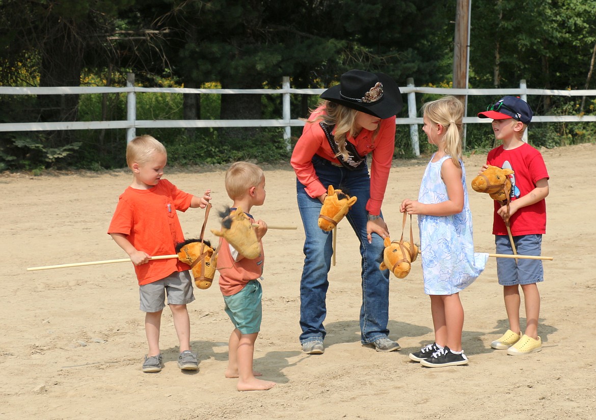 Miss Sandpoint Rodeo Maddie Gunter explains the rules of the World's Smallest Rodeo to interested cowboys and cowgirls at the Bonner County Fair on Friday.