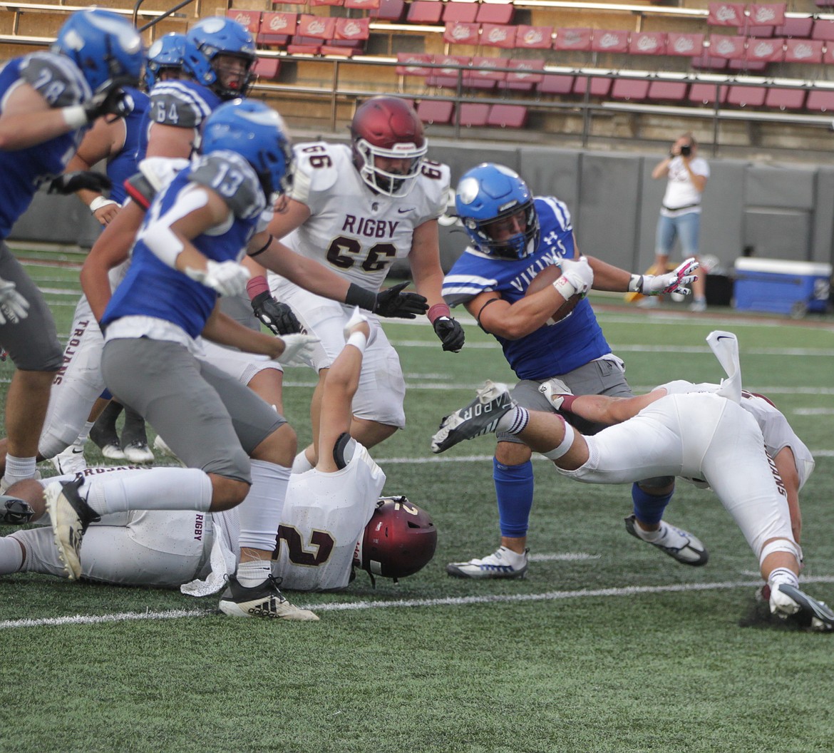 JASON ELLIOTT/Press
Coeur d'Alene junior running back Kruz Wheeler battles through the Rigby defensive line during the second quarter of Friday's game at Washington-Grizzly Stadium in Missoula, Mont.