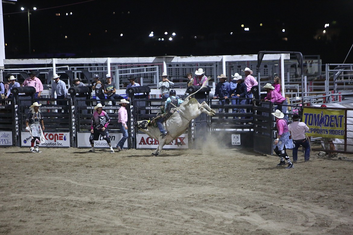 A rider attempts to stay atop a bull during the bull riding event Thursday evening.
