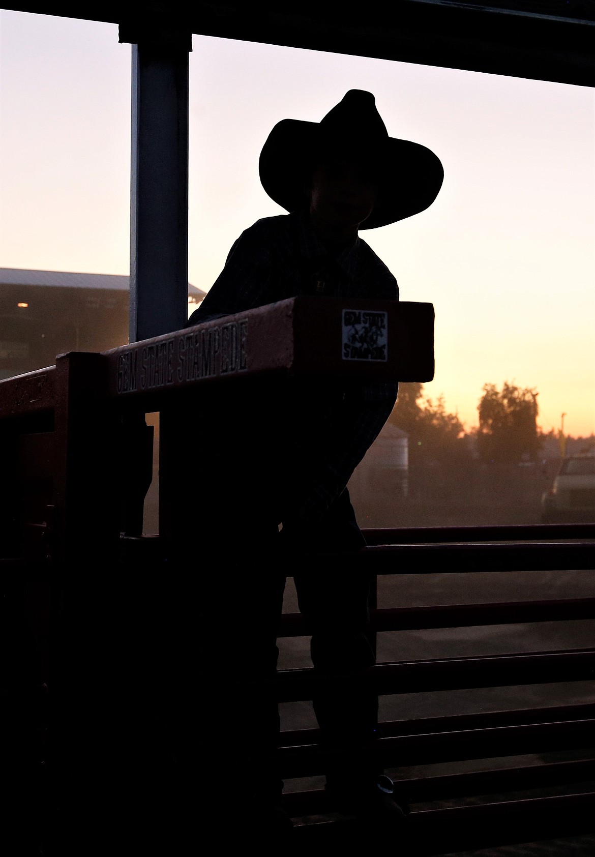Hank Jones is silhouetted as he looks out at the Kootenai County Fairgrounds.