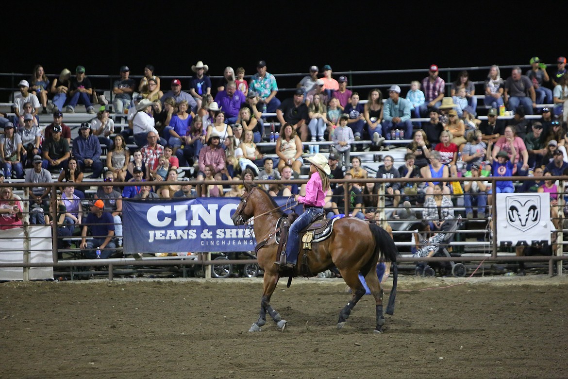 Macy Young looks up at the scoreboard after her event-leading 2.2 second performance in the breakaway roping competition.