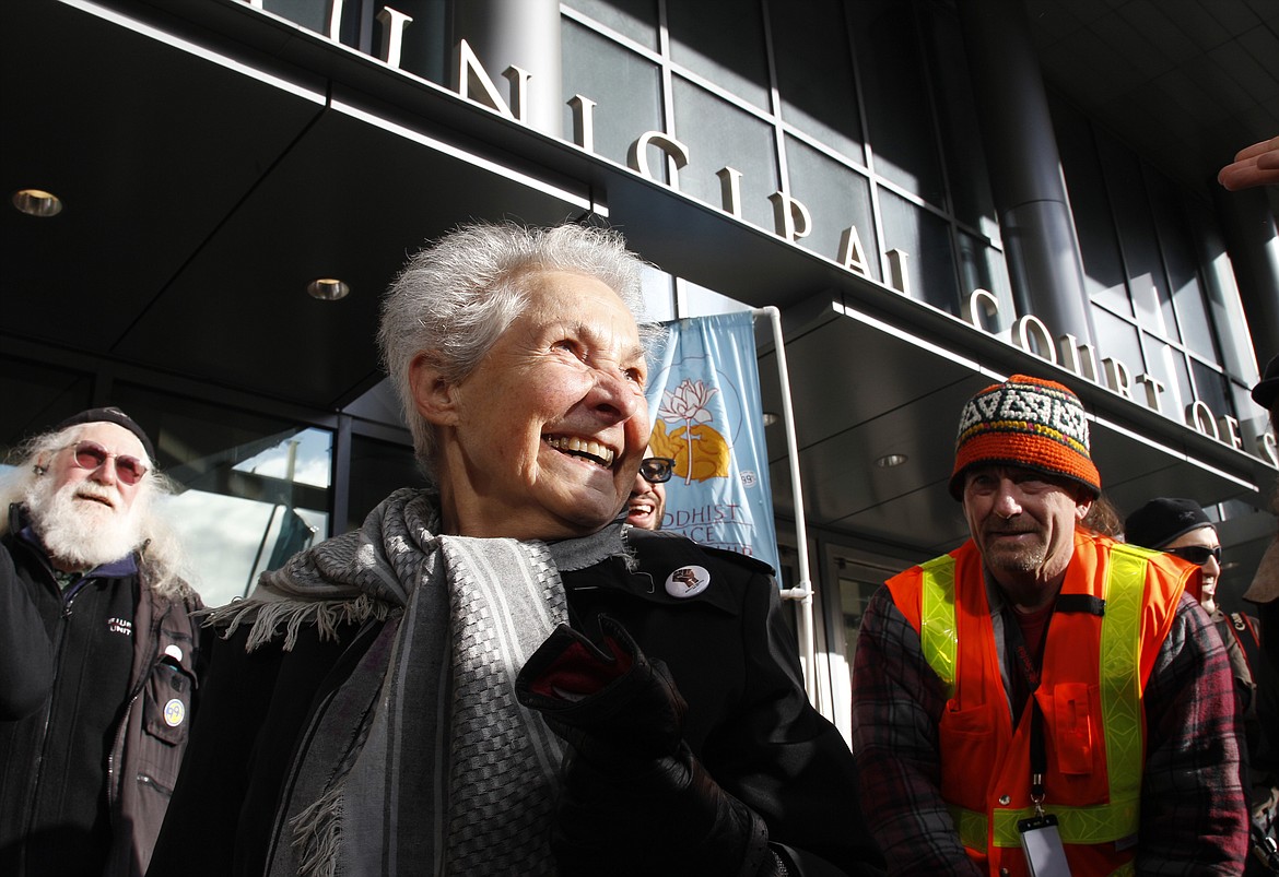 Dorli Rainey, 84, center, who was pepper-sprayed by police while taking part in an "Occupy Seattle" protest, smiles before speaking on Nov. 18, 2011, in front of police headquarters in downtown Seattle. Rainey, who became a symbol of the Occupy protest movement after she was pepper-sprayed by Seattle police in 2011, has died on Aug. 12, 2022, at age 95. Her daughter, Gabriele Rainey, said her mom was “so active because she loved this country, and she wanted to make sure that the country was good to its people.” (AP Photo/Ted S. Warren, File)