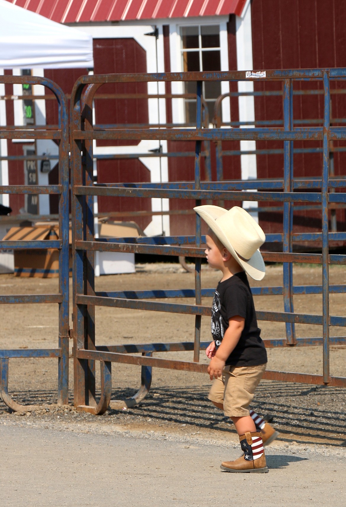 A young cowboy walks through the Bonner County Fairgrounds on Saturday.