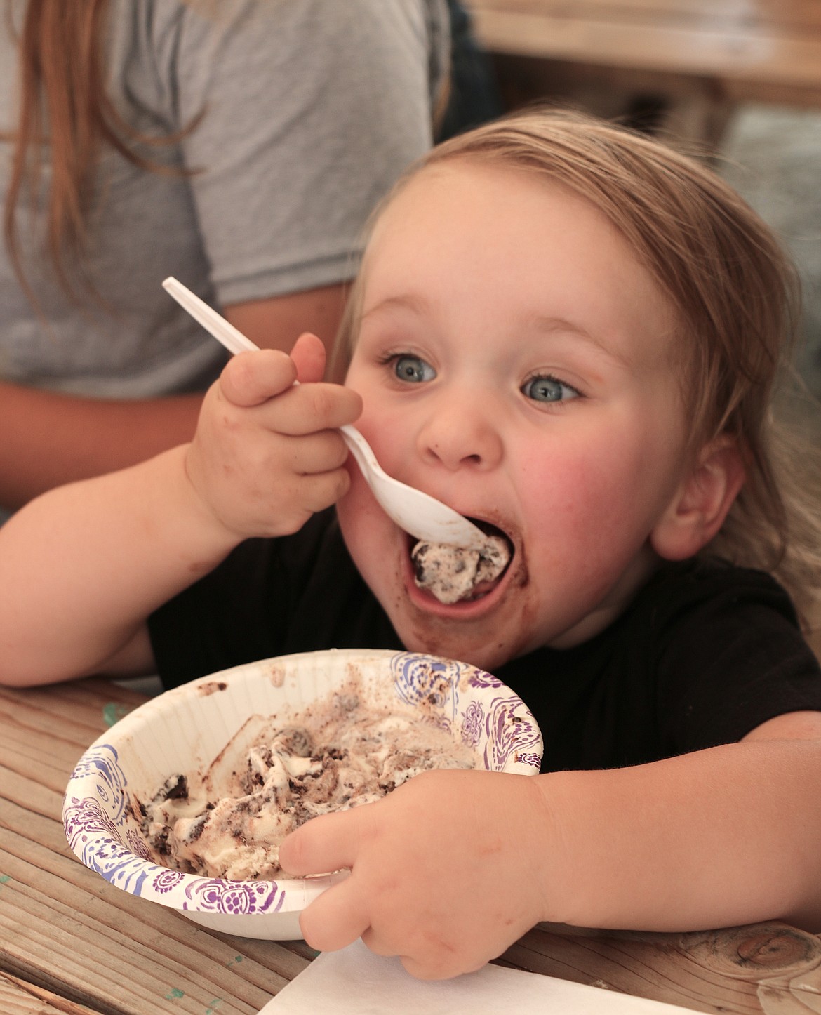 A young contestant opens wide for a big bite of ice cream during an ice cream eating contest at the Bonner County Fair on Saturday.