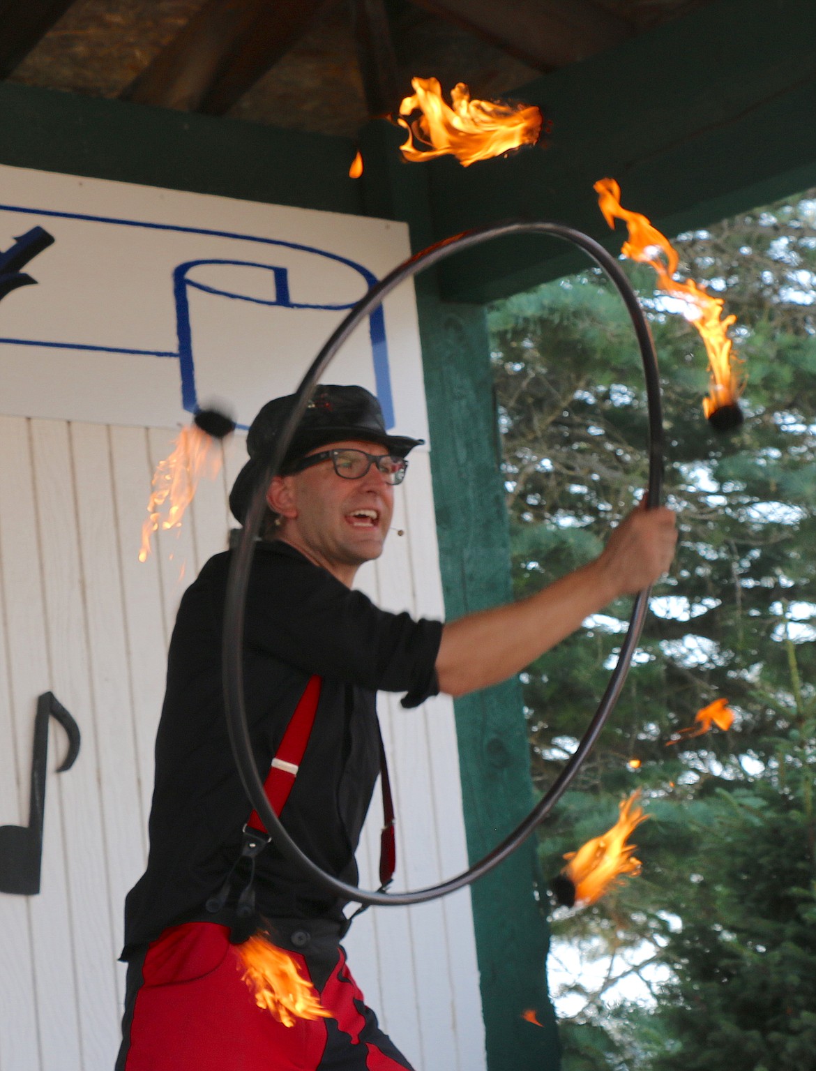 Peter Brunette spins a ring of fire during his juggling act at the Bonner County Fair on Saturday.