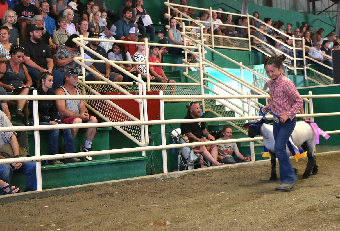 Maylie Spohn takes her sheep around the arena as she sells it at the Market Animal Sale on Saturday at the Bonner County Fair.