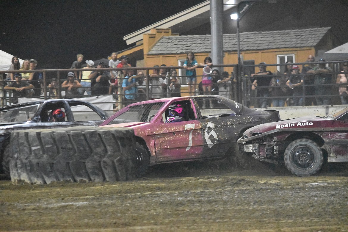 Cindy Welsh, in the pink and sparkled car, is pinned between two other cars and a tire during her heat of the demo.