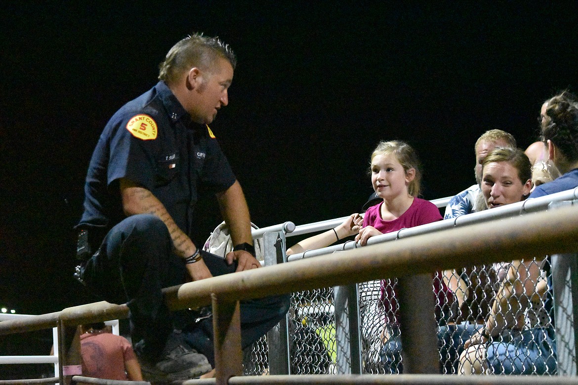 GCFD5 Captain Travis Svilar talks with some young attendees of the demo derby. Svilar said the department loves coming out to events like the demo derby to connect with the community and help build relations outside of emergency situations.