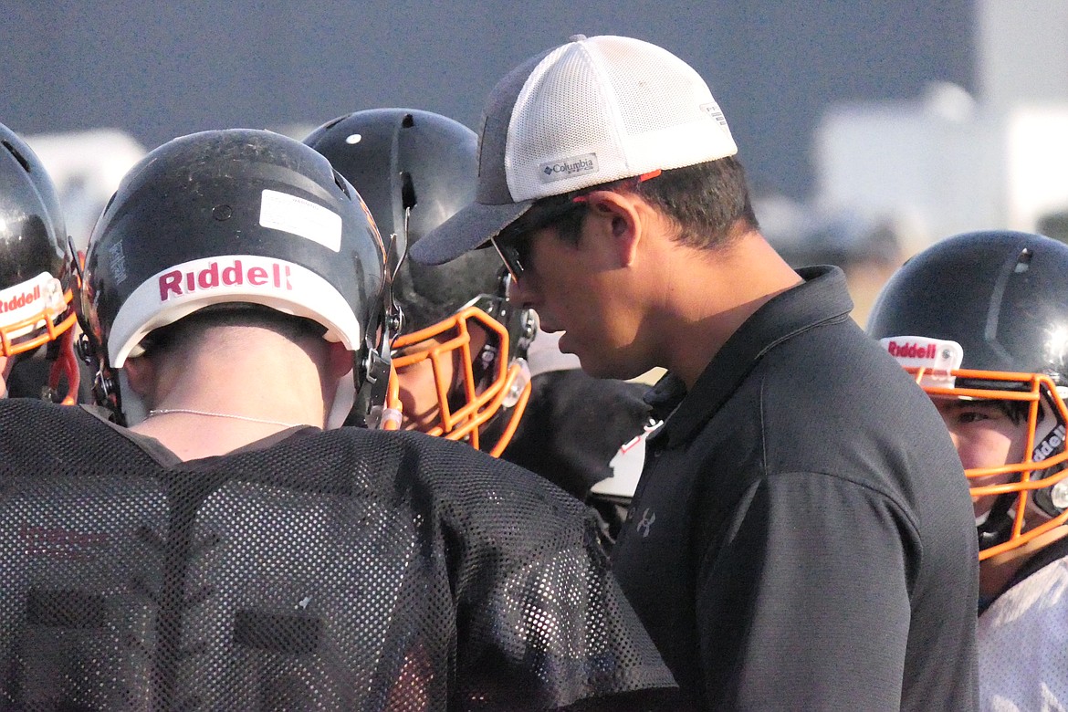 Coach Ryan Hart goes over plays with Horsemen hopefuls during a recent practice in Plains.  (Chuck Bandel/VP-MI)