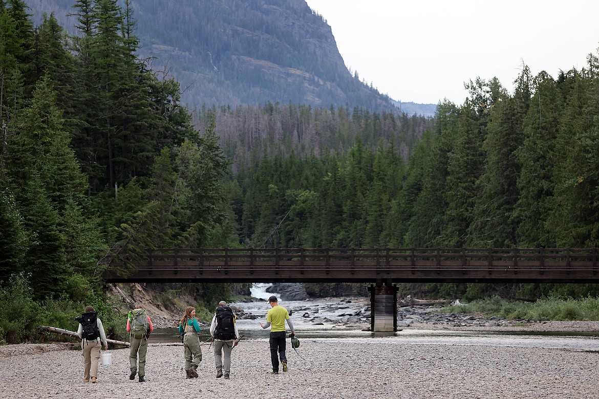 Glacier National Park scientists and volunteers pass beneath the Upper McDonald Creek Bridge during a harlequin duck study earlier this month. (Jeremy Weber/Daily Inter Lake)