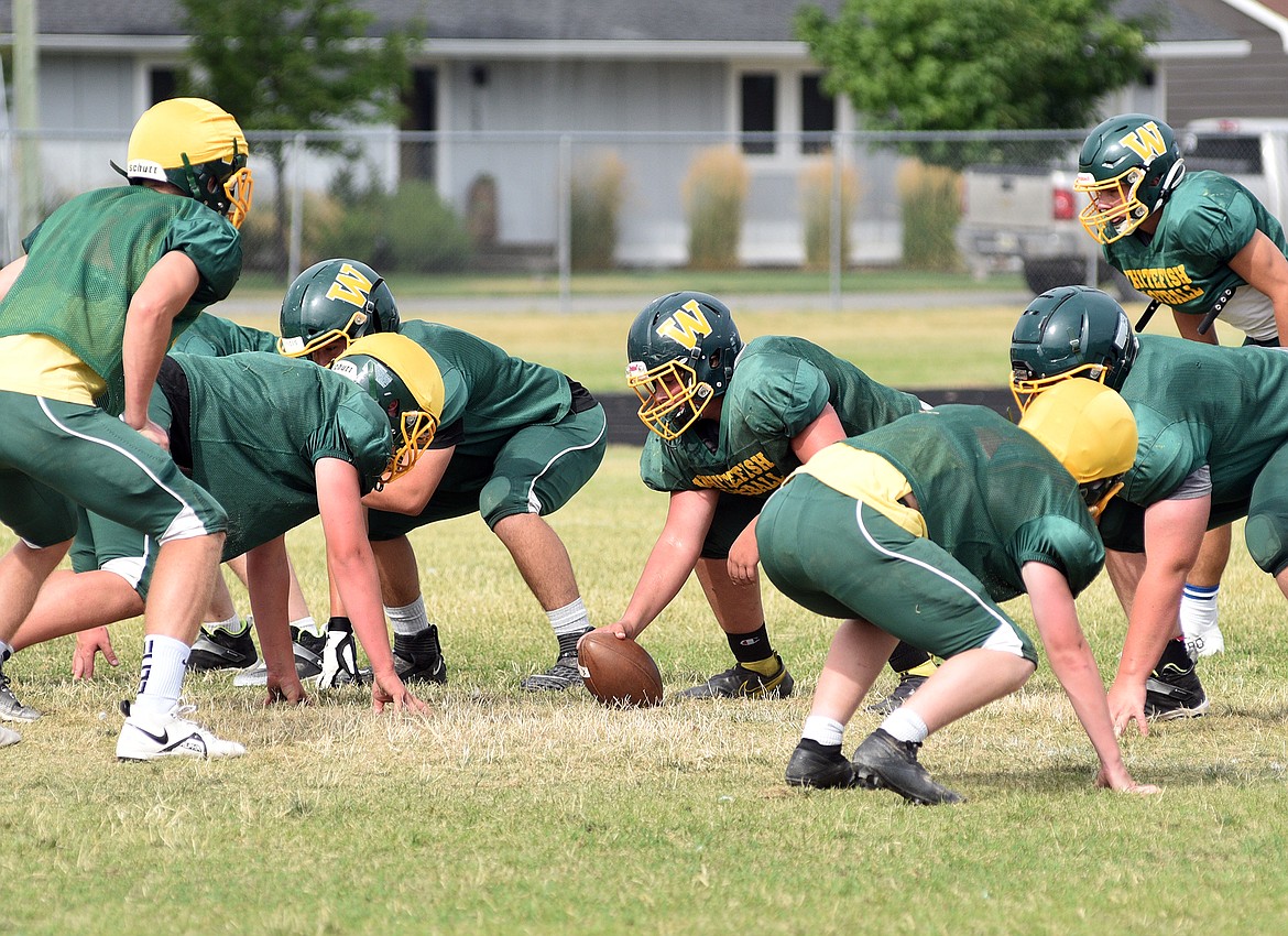 Bulldogs line up for a drill during practice at WHS on Monday. (Whitney England/Whitefish Pilot)