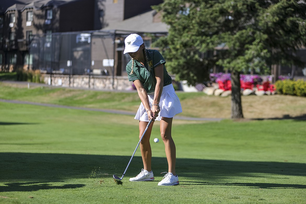 Whitefish junior Leia Brennan hits a chip onto the green at Whitefish Lake Golf Course on Tuesday. (JP Edge photo)