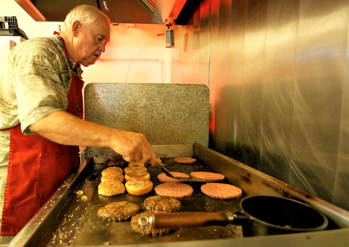 Glen Abbott works the grill for the Knights of Columbus at the fair Tuesday.