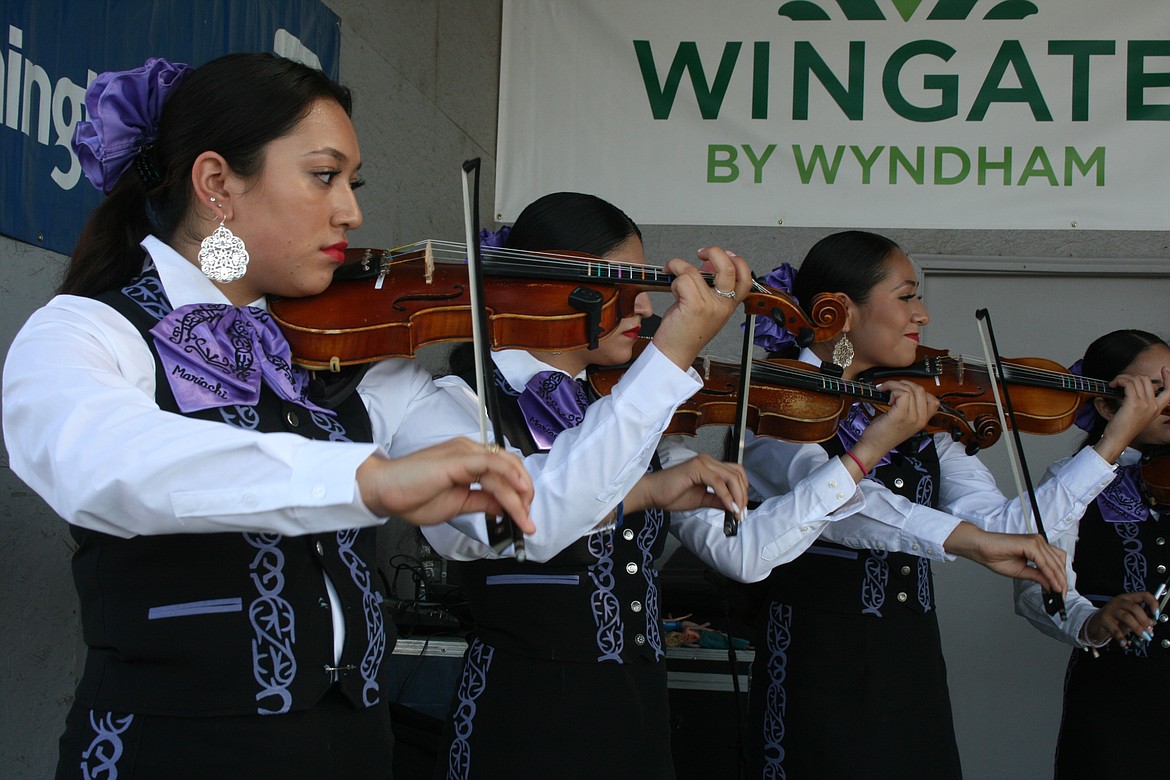 Violinists with Mariachi Huenachi provide the melody during Saturday’s performance at the Grant County Fair.