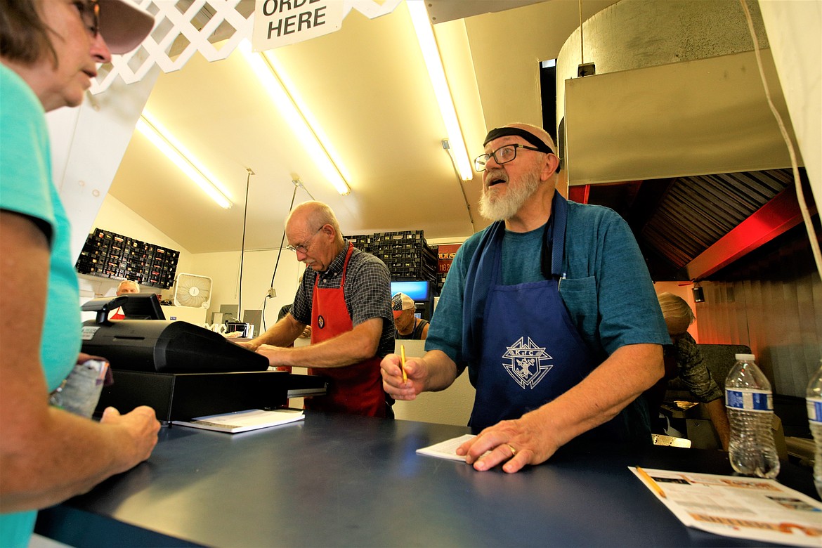 Lee Lutovsky, right, and Craig Frei man the front counter at the Knights of Columbus Dog House at the North Idaho State Fair on Tuesday.