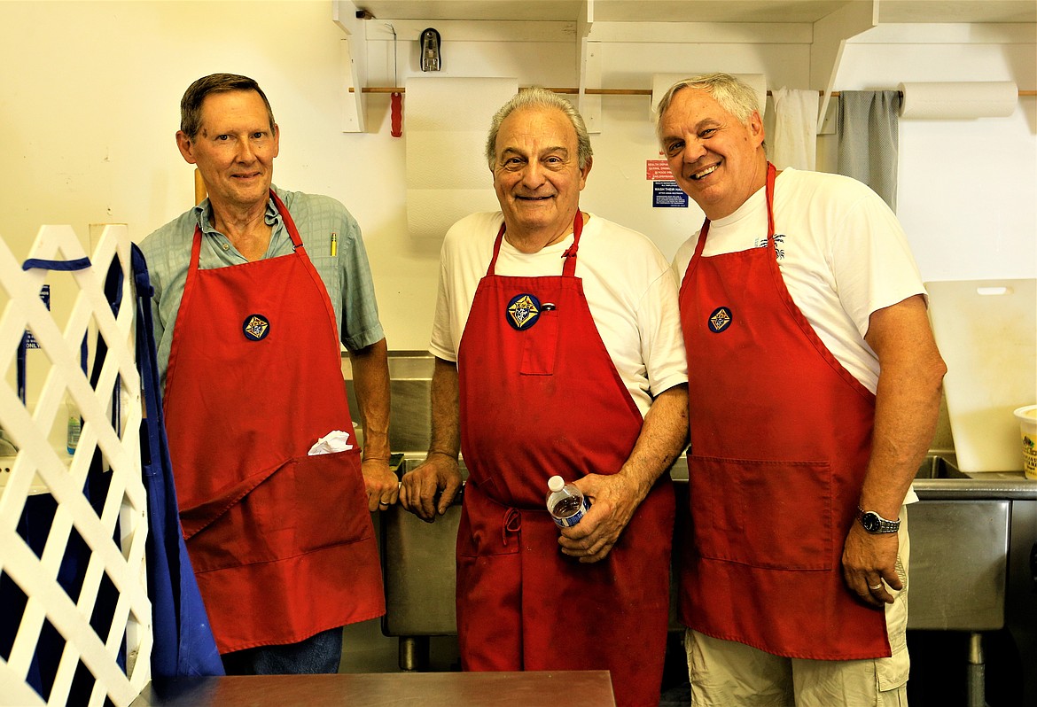 Knights of Columbus members, from left, Gary Fessler, Ray Stongle and Darryl Cutler are all smiles in the Dog House at the North Idaho State Fair on Tuesday.