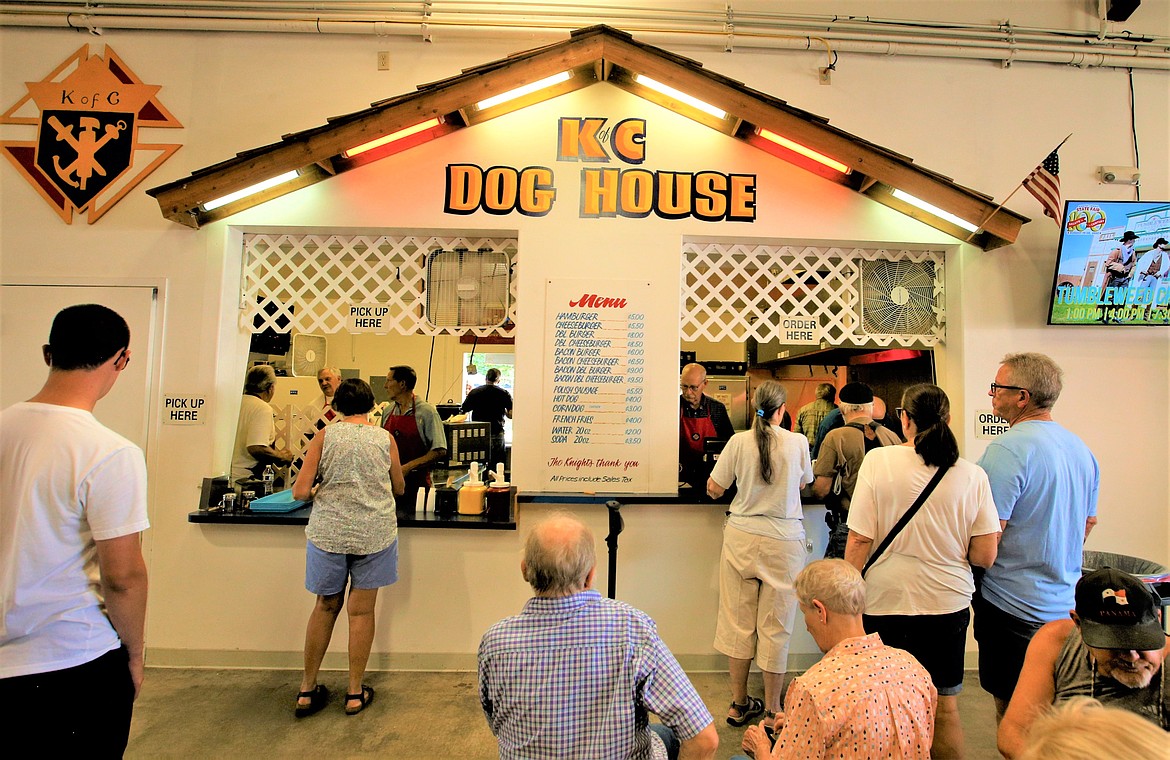 Customers line up at the Knights of Columbus Dog House on Tuesday.