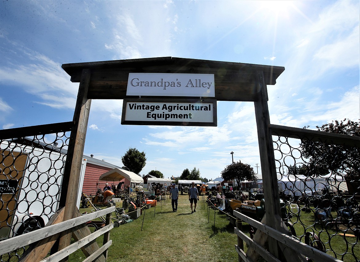 Two men walk toward through Grandpa's Alley at the North Idaho State Fair on Wednesday.