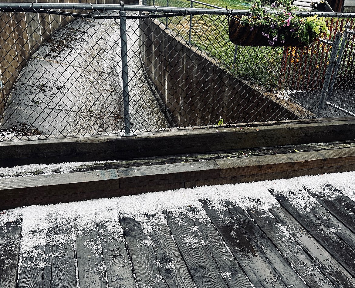 Hail coats the side of the Placer Creek bridge on River Street Thursday afternoon.