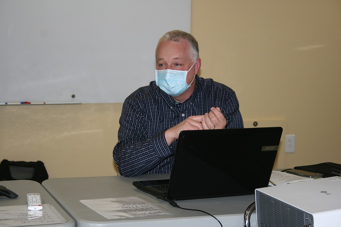 Luke Zarecor, an accountant for Quincy Valley Medical Center, goes over the results of the hospital’s 2021 financial audit during the commission meeting Tuesday.