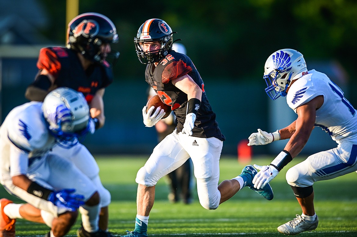 Flathead running back Gabe Lake (32) looks for running room against Billings Skyview in the second quarter at Legends Stadium on Friday, Aug. 26. (Casey Kreider/Daily Inter Lake)