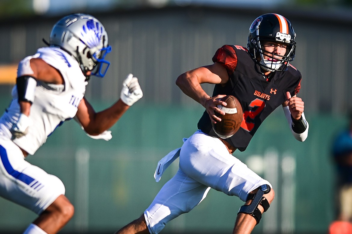 Flathead quarterback Jackson Walker (2) runs for a first down in the first quarter against Billings Skyview at Legends Stadium on Friday, Aug. 26. (Casey Kreider/Daily Inter Lake)