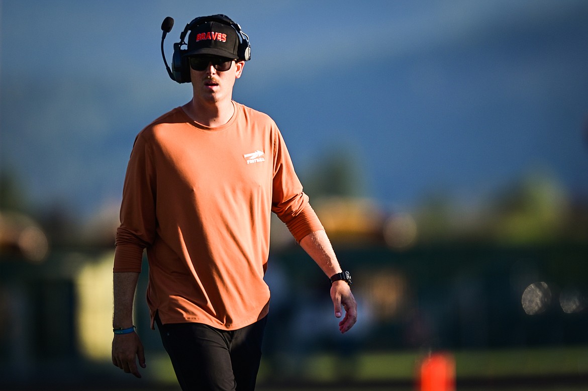 Flathead head coach Caleb Aland walks the sidelines as the Braves take on Billings Skyview at Legends Stadium on Friday, Aug. 26. (Casey Kreider/Daily Inter Lake)