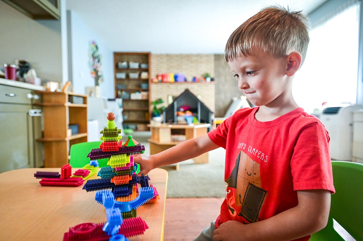 Noah plays with a set of building blocks inside the preschool at The Birds Nest Early Learning Village on Friday, Aug. 26. (Casey Kreider/Daily Inter Lake)