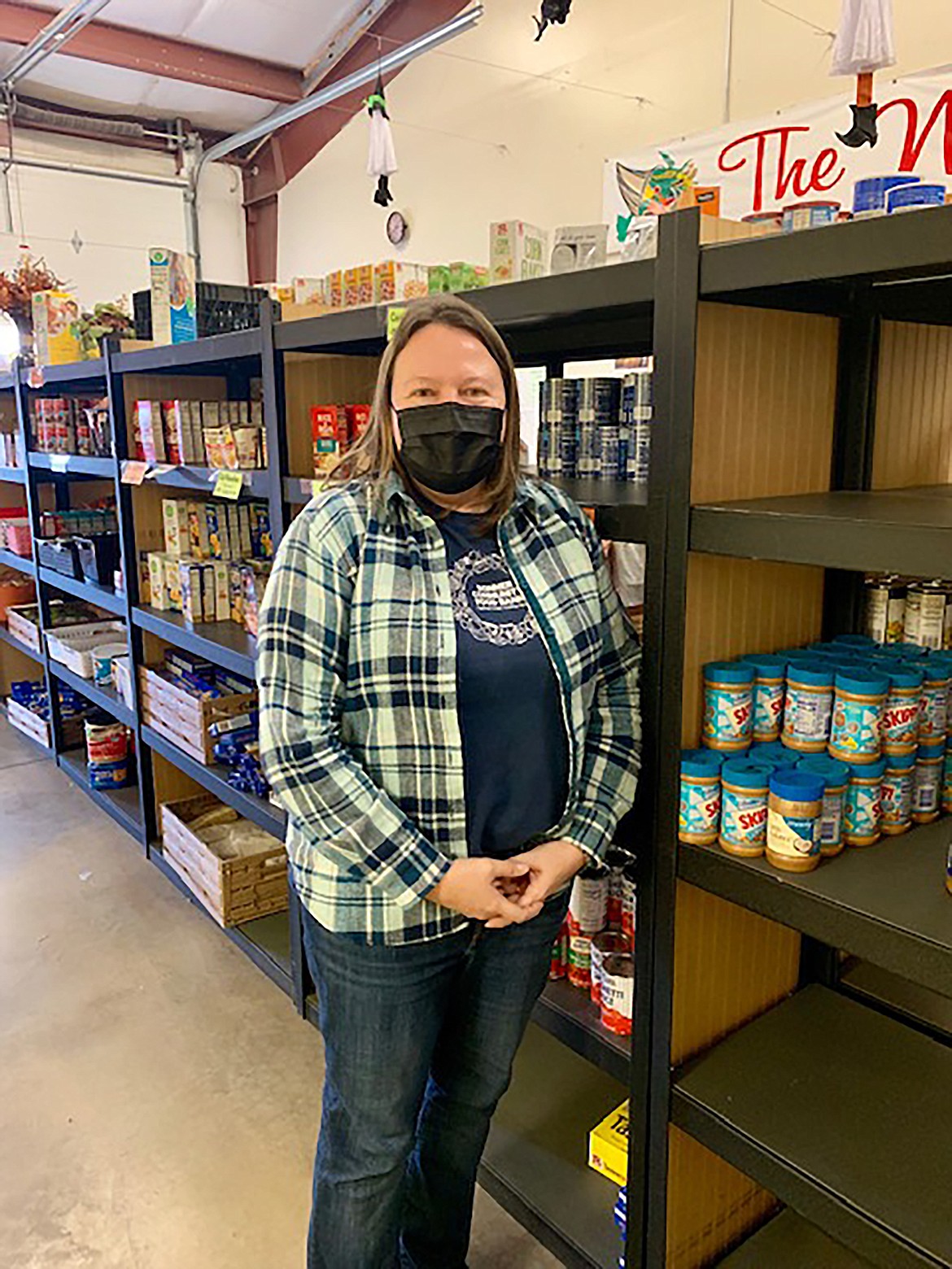 Above, heavy demand has left the Bonner Community Food Bank is in need of some serious assistance from the public. Above, BCFB Executive Director Debbie Love stands by a few of the facility's shelves late last year.