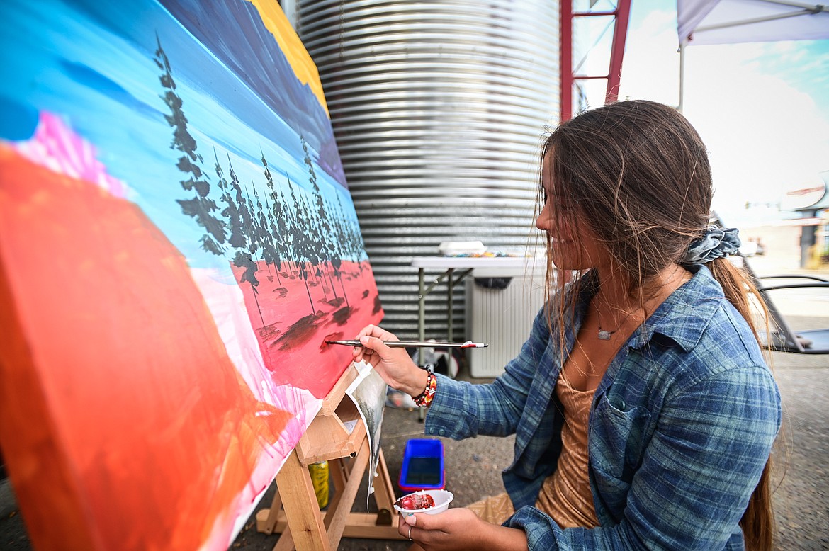 Artist Genevieve Delorme works on a rendition of a Clarence Rundell mural for the Kalispell Downtown Association and KALICO Art Center's Downtown Art Challenge on Saturday, Aug. 27. Ten artists each referenced a different Clarence Rundell mural that Rundell painted in 1936 in what is now Rocky Mountain Outfitter on Main Street in Kalispell. The paintings will be hung up and on view in  several downtown businesses from Aug. 31 to Sept. 8, during which time all of the paintings will be up for auction on the following online platform: https://app.galabid.com/kdachallenge/items. (Casey Kreider/Daily Inter Lake)