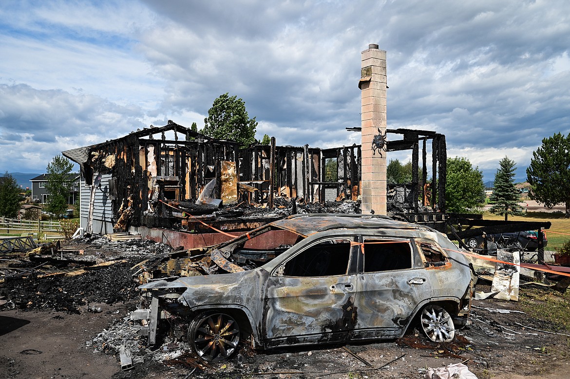 One of two automobiles belonging to the Brewer/Works family lost in a house fire along Tronstad Road, shown on Saturday, Aug. 27. (Casey Kreider/Daily Inter Lake)