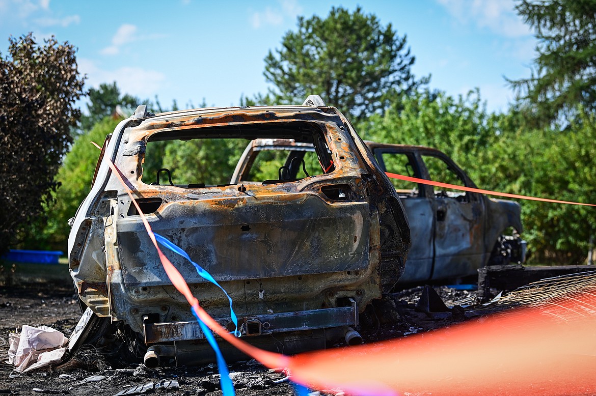 Two automobiles belonging to the Brewer/Works family lost in a house fire along Tronstad Road, shown on Saturday, Aug. 27. (Casey Kreider/Daily Inter Lake)