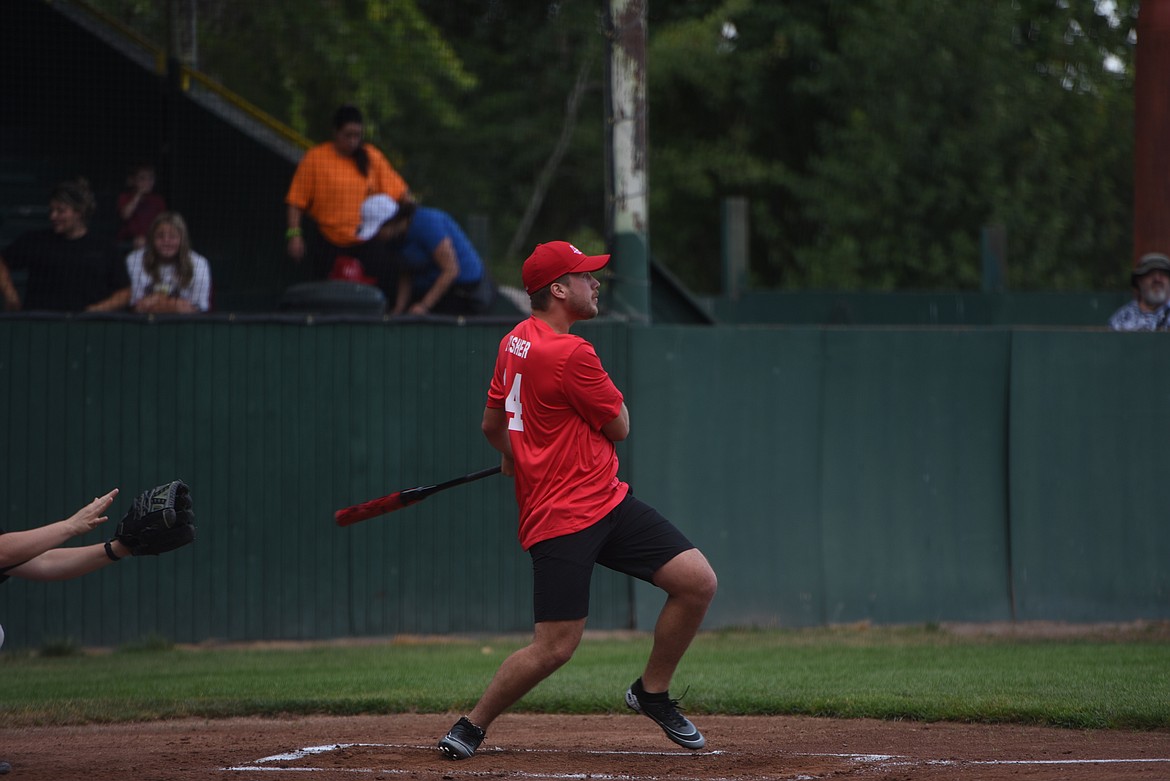 Libby Volunteer Fire Department member Jonathan Fisher watches a ball he hit during the Fifth Annual Guns and Hoses softball game on Thursday, Aug. 30. (Scott Shindledecker/The Western News)