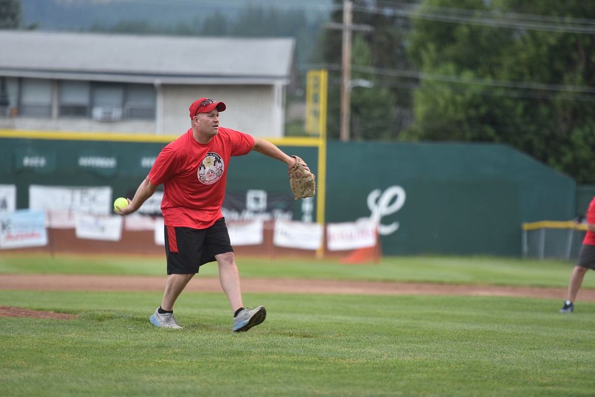 Libby Volunteer Fire Department member throws a pitch during the Fifth Annual Guns and Hoses softball game on Thursday, Aug. 30. (Scott Shindledecker/The Western News)