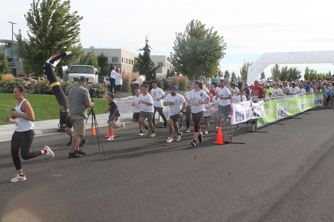 Runners stampede from the starting line at the Columbia Basin Health Association’s Color Run Saturday.