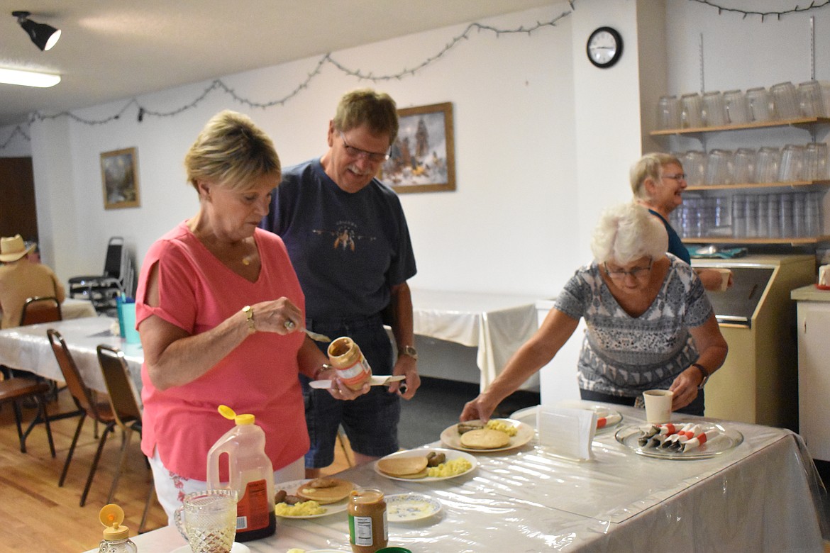 Each attendee received their plate of pancakes, eggs and two sausage links and then find their way to the toppings table to add butter, syrup or peanut butter to their pancakes.