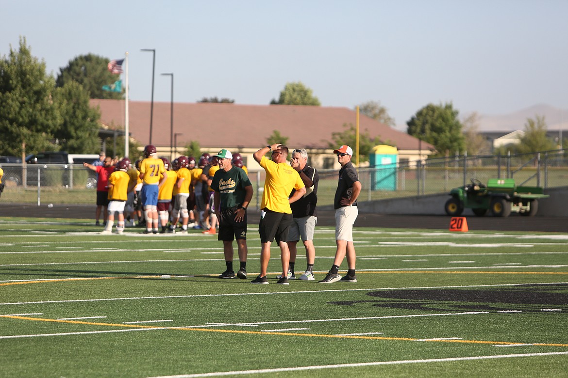 Quincy Head Coach Russ Elliott, left, Moses Lake head coach Brett Jay, middle left, Royal Head Coach Wiley Allred, middle right, and Ephrata Head Coach Patrick Mitchell, right, meet at midfield prior to the jamboree.