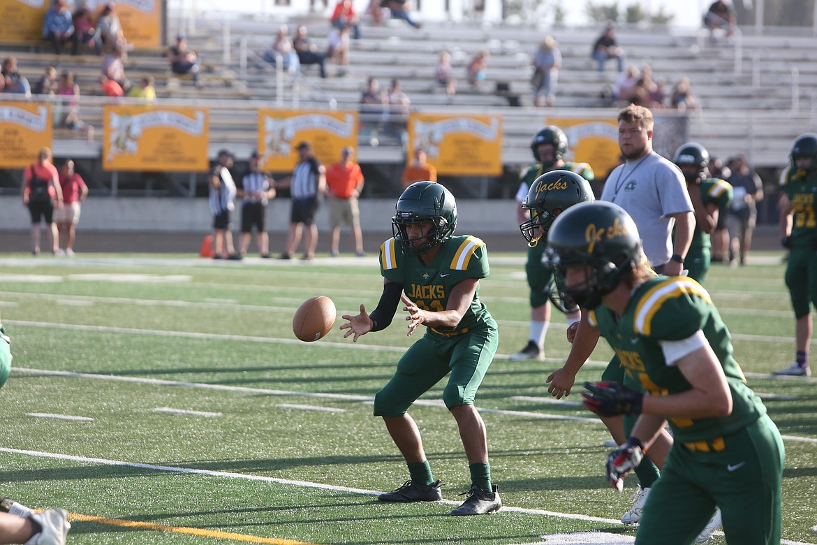 Quincy’s Gavin Gonzalez prepares to take the snap during warmups before the jamboree.