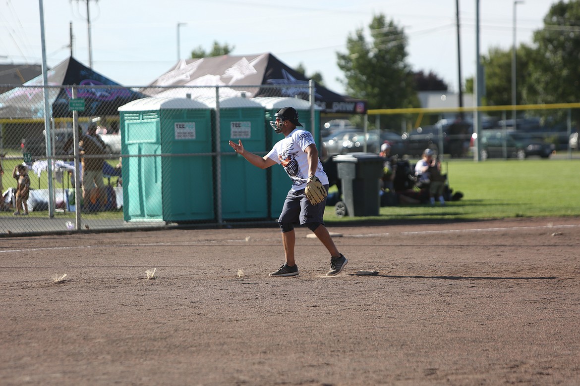 The slowpitch-style tournament features underhand pitching, as shown by this Los Perros pitcher in the circle.