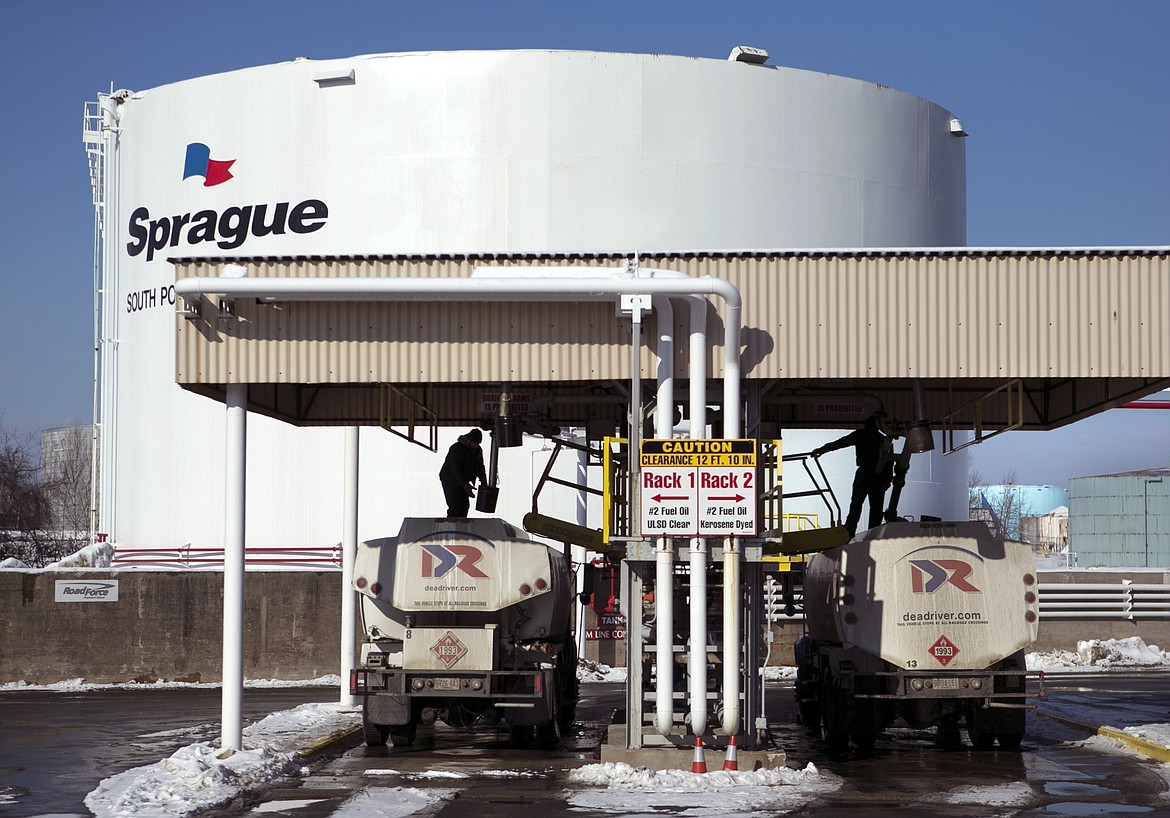 FILE - Drivers for an oil delivery company fill their trucks at the Sprague terminal, on Jan. 16, 2014, in South Portland, Maine. Diesel and heating oil supplies in the Northeast are more than 50% below the recent average, raising concerns that an extreme weather event could cause supply disruptions, federal officials said. (AP Photo/Robert F. Bukaty, File)