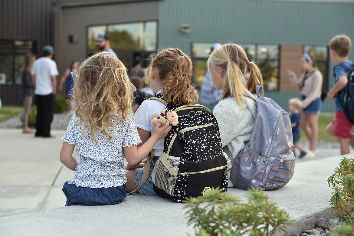 A trio wait for the opening bell of the first day of school at Muldown Elementary in Whitefish last week. (Julie Engler/Whitefish Pilot)