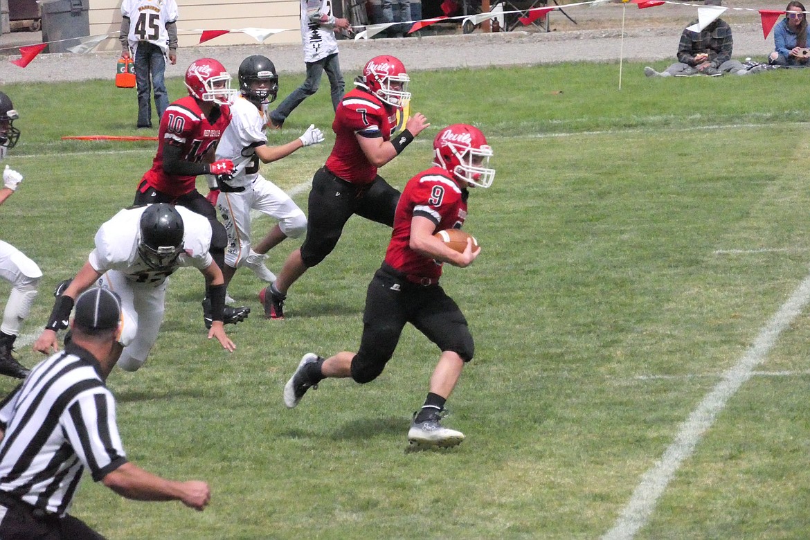 Red Devil running back Shamus Wheeldon breaks past Heart Butte defenders on his way to a touchdown during Noxon's 57-12 win over the Warriors Saturday afternoon in Noxon.  (Chuck Bandel)