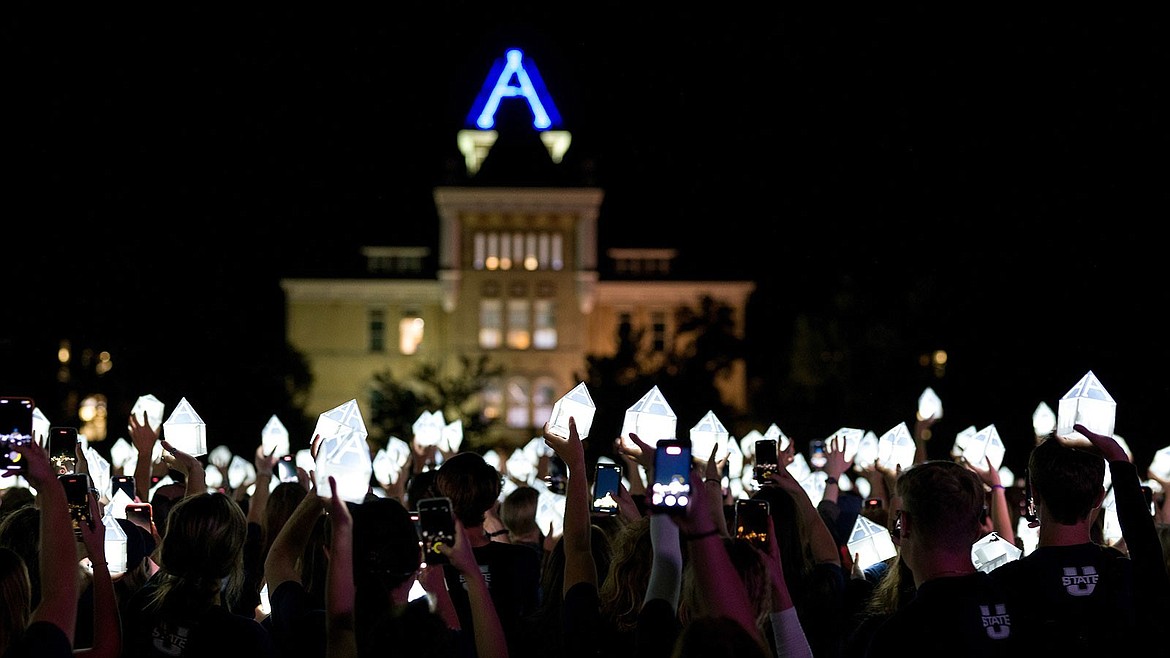 Students hold lanterns near Old Main during the 2022 Luminary ceremony the Friday before the first day of classes.