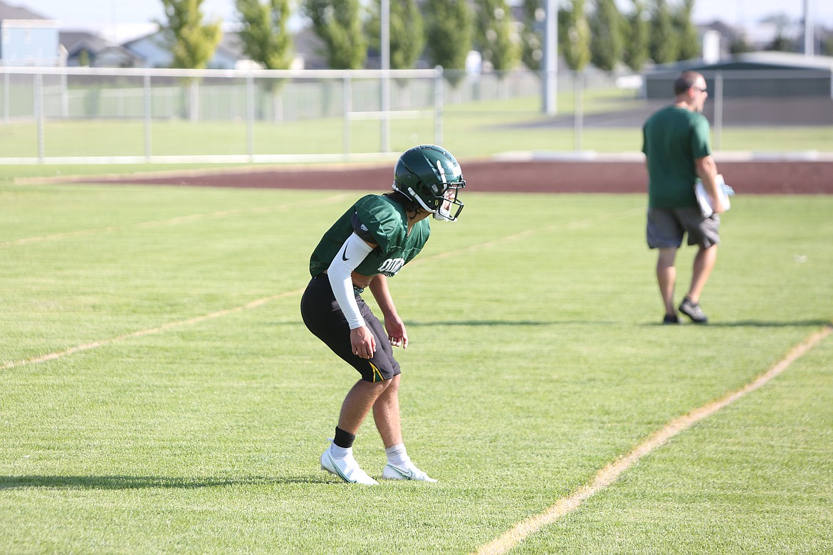 Jackson Yeates looks on at the Quincy scout team offense during team drills.