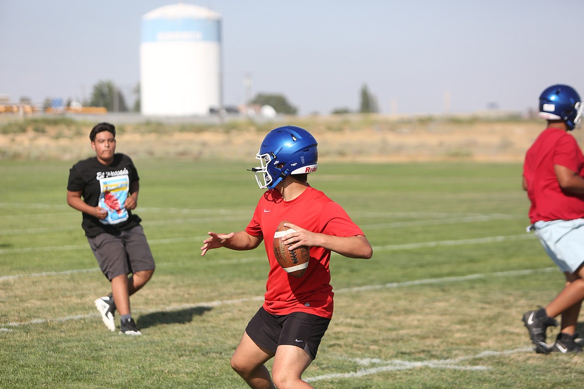 Warden sophomore quarterback Elijah Ruiz throws the ball deep during a walkthrough practice.